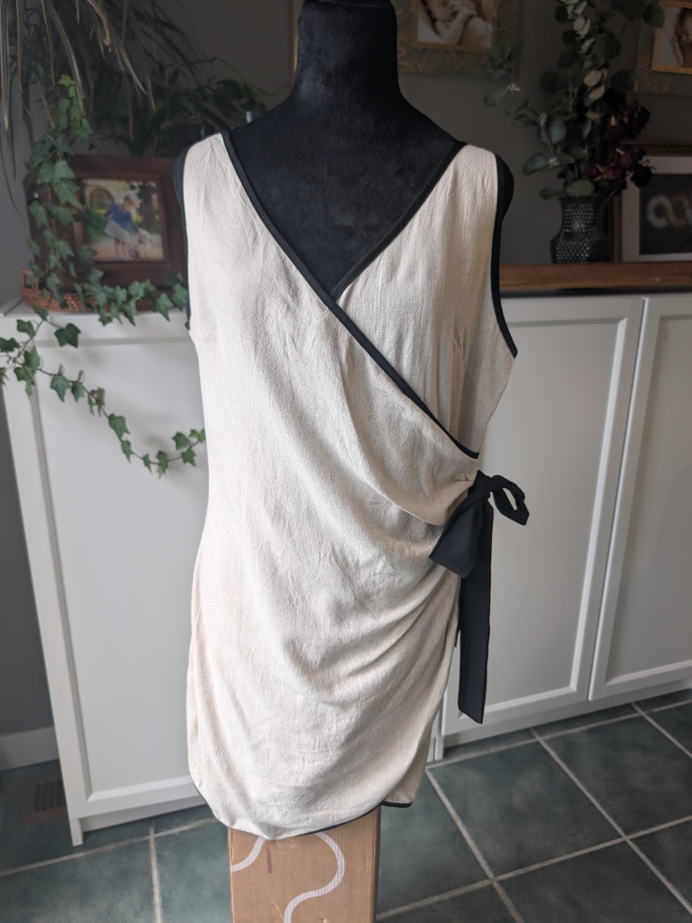 Sleeveless Cream Wrap Dress with Black Trim